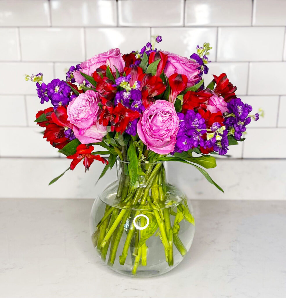 pink garden roses, red lilies, purple stock