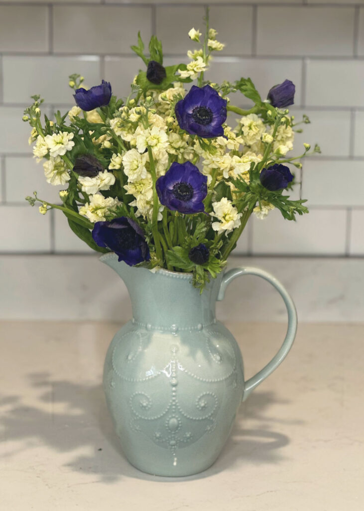 White stock flowers and blue anemone/poppy flowers, light blue vase, blue pitcher vase, Lenox French Perle vase, floral arranging, floral accessories