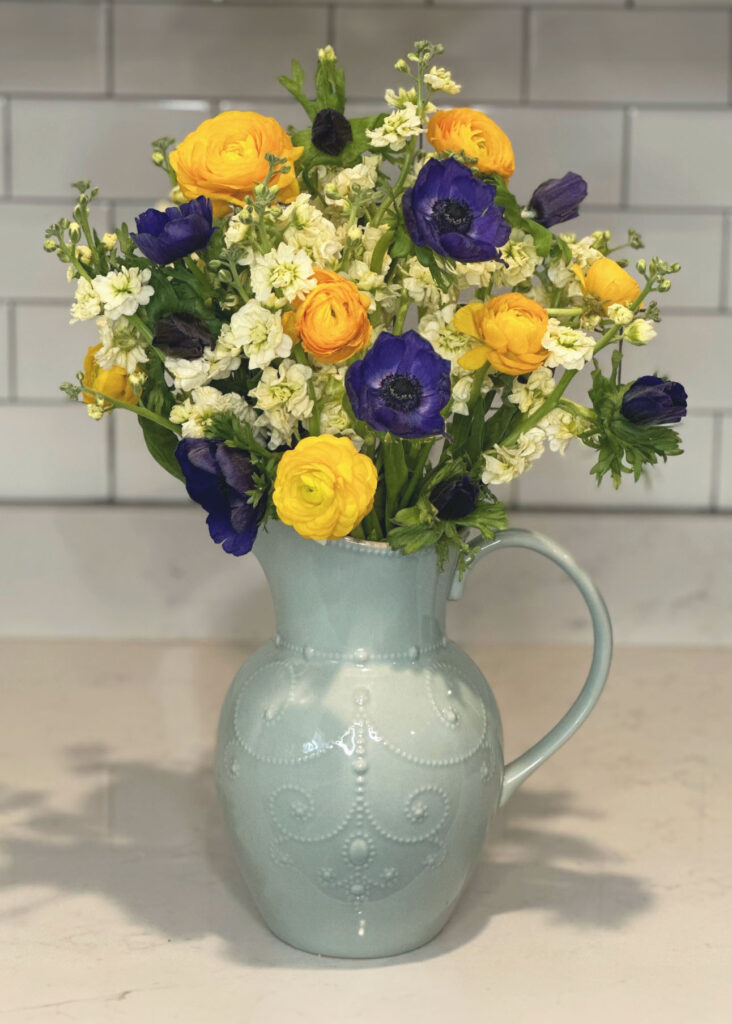 White stock flowers, blue anemone flowers, yellow Ranunculus flowers, light blue vase, blue pitcher vase, Lenox French Perle vase, floral arranging, floral accessories