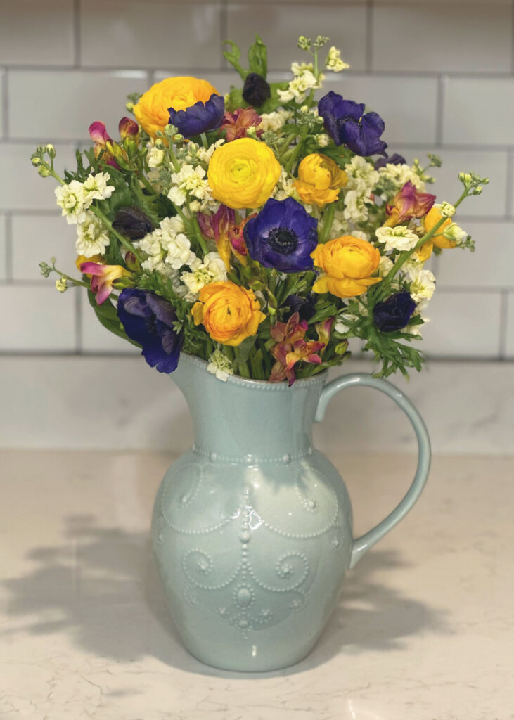 White stock flowers, blue anemone flowers, yellow Ranunculus flowers, Pink & Yellow Freesia, light blue vase, blue pitcher vase, Lenox French Perle vase, floral arranging, floral accessories