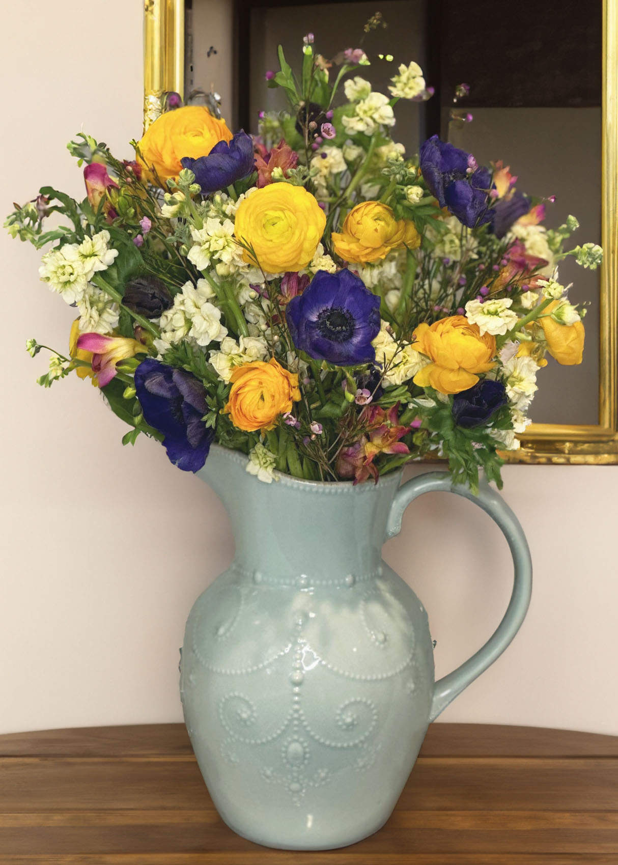 White stock flowers, blue anemone flowers, yellow Ranunculus flowers, Pink & Yellow Freesia, light blue vase, blue pitcher vase, Lenox French Perle vase, floral arranging, floral accessories, golden mirror