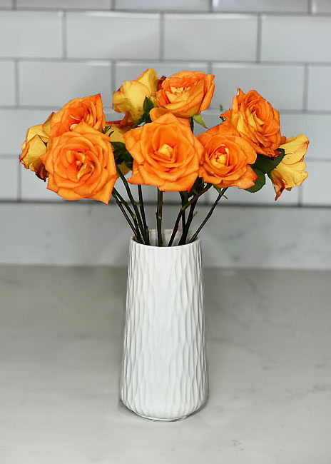 Bright orange roses in white vase, summer and spring bouquets, bright and cheerful flowers