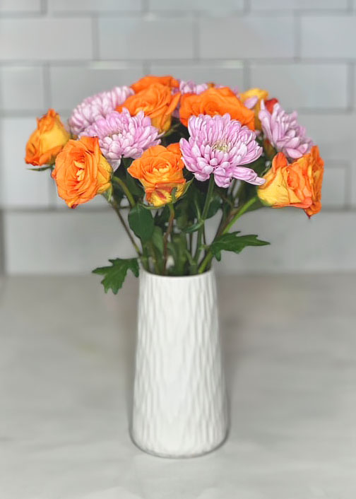 Bright orange roses in white vase, summer and spring bouquets, bright and cheerful flowers, pink mums, purple Chrysanthemums