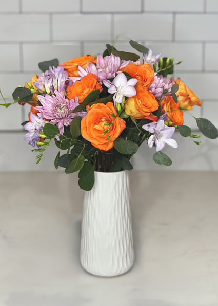 Bright orange roses in white vase, summer and spring bouquets, bright and cheerful flowers, pink mums, purple Chrysanthemums, purple freesia, Silver Dollar Eucalyptus