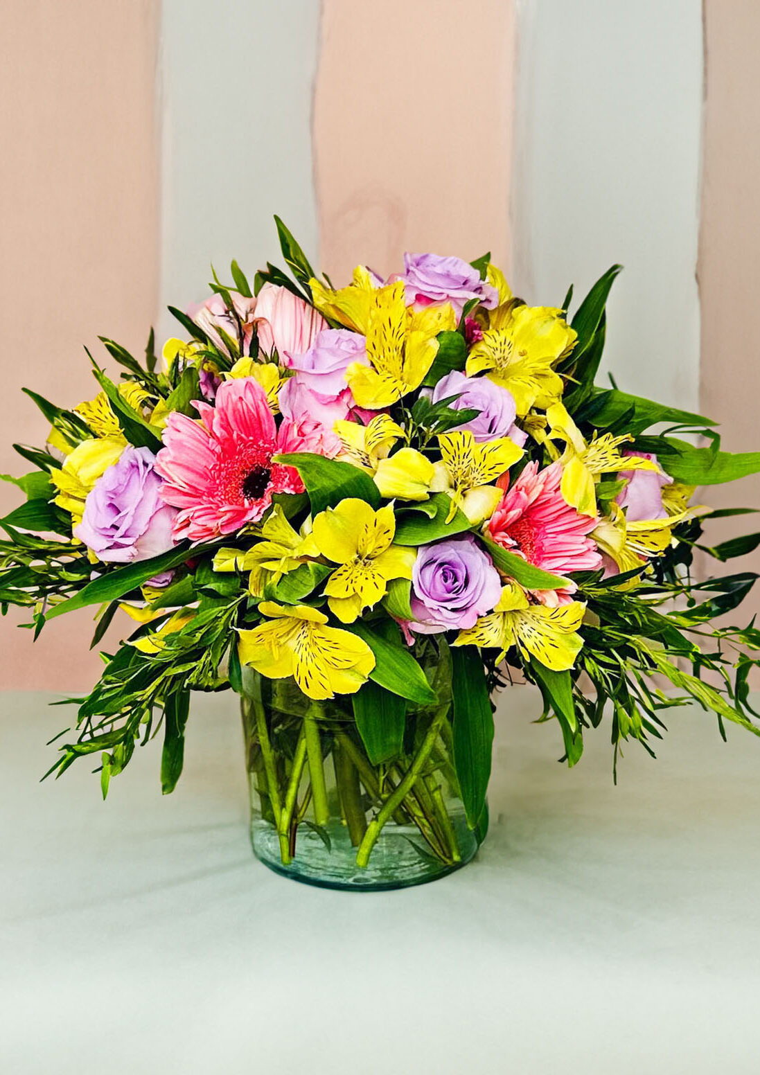 pretty pastels bouquet, daisies, alstroemeria, purple roses, everyday bouquet, clear low-profile cylinder vase, floral arrangement, spring, bright and cheerful bouquet