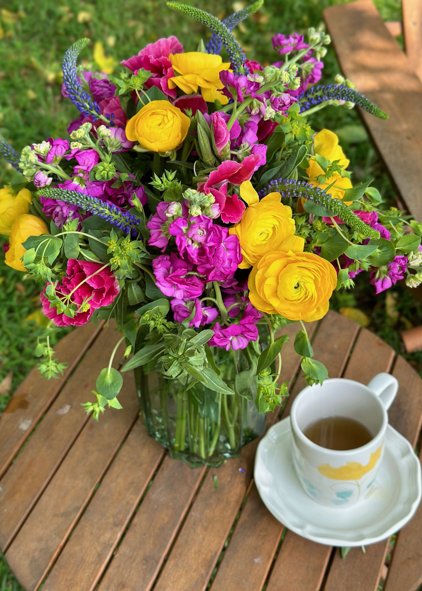 Bright beautiful flowers, green glass vase, flower arrangement, ranunculus, veronica, stock flowers, godetia, hare's ear, home decor, floral inspiration